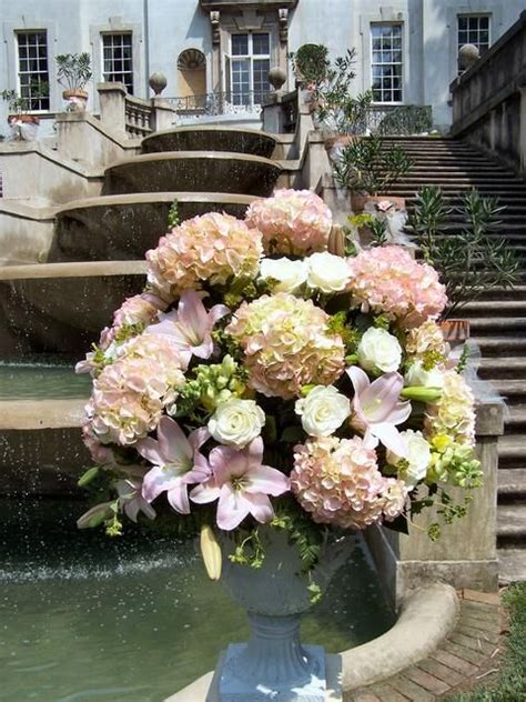 Many factors affect flower prices. Lush altar flower arrangement, featuring pink hydrangeas ...