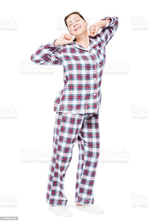 Woken Up Girl In Pajamas Stretching On A White Background Full Length