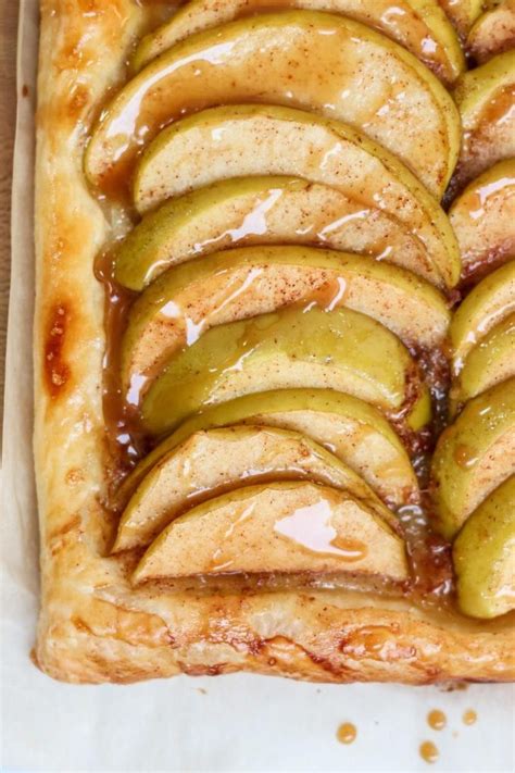 An Apple Tart With Caramel Drizzled On Top And Sliced Apples In The Middle