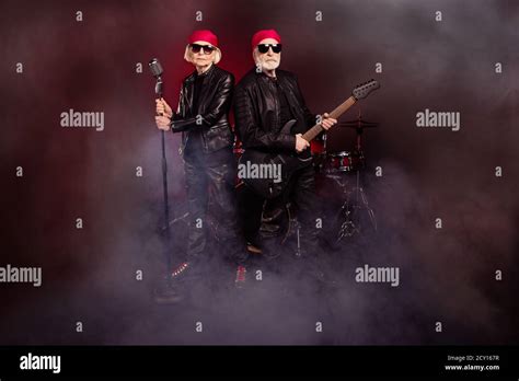 Full Body Photo Of Two Aged Lady Man Rock Group Perform Concert Play Solo Guitar Fog Air Sing