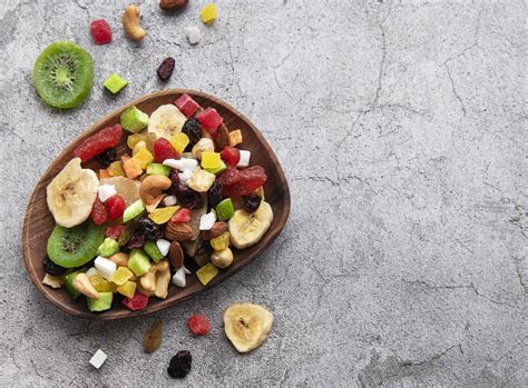 Bowl With Various Dried Fruits And Nuts On A Gray Concrete Background