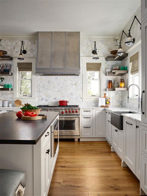 Their existence is not only to shield the wall behind the countertops but to adorn the area around the kitchen cabinets. Transitional Kitchen With Countertop-To-Ceiling Backsplash | HGTV