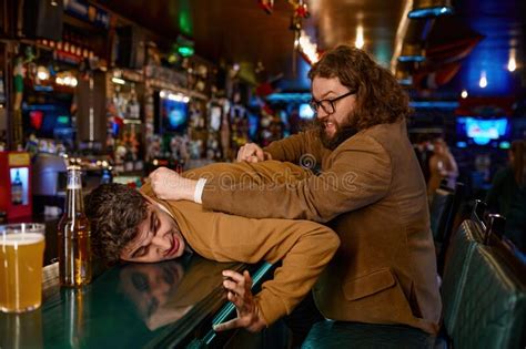 Aggressive Man Pulling Guy On Bar Counter Stock Image Image Of Match