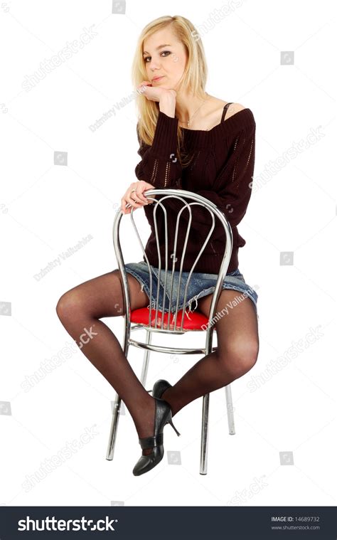 Thoughtful Beautiful Young Woman Sitting On A Chair Isolated On White