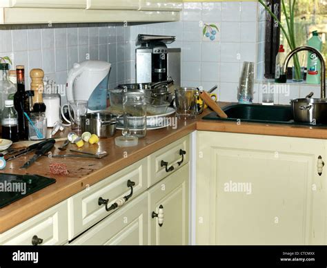 Messy Kitchen Counters With Dirty Plates Cutlery And Glasses Stock