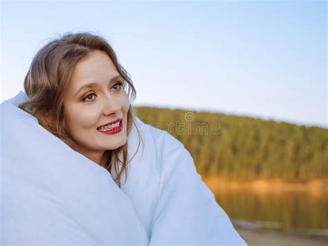 Woman Wrapped In A Blanket Standing On The Shore Enters The Day Happy