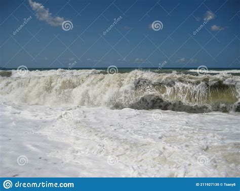 Storm On The Seashore High Wave And Sea Foam On The Shore On A Sunny