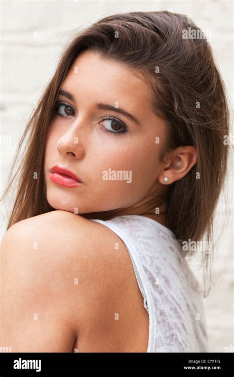 Portrait Headshot Of A Beautiful Woman Looking Over The Shoulder Stock