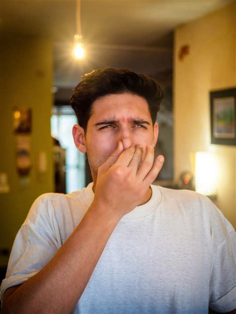 Disgusted Man Pinching Nose In Blurred Room Stock Image Image Of