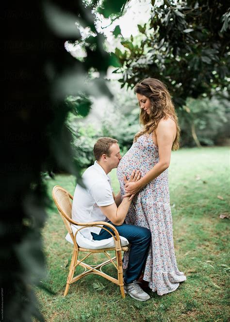 Maternity Session With Man Kissing Wifes Pregnant Belly By Stocksy