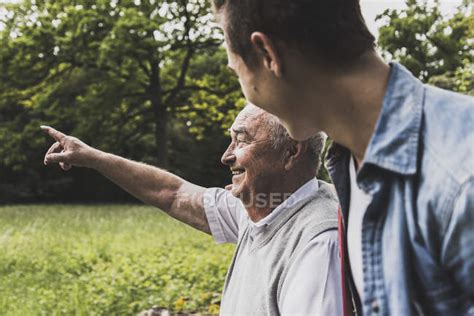 Happy Grandfather And Grandson In Nature — Talking Men Stock Photo