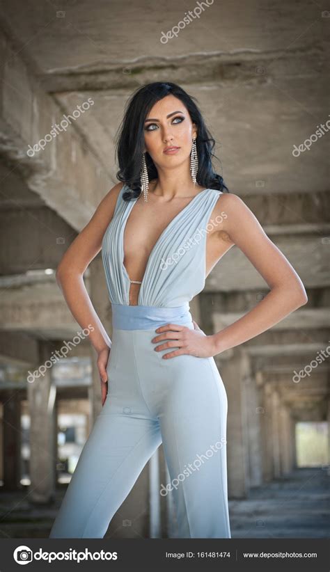 Portrait Of Beautiful Sexy Young Woman With Elegant Overall In Urban