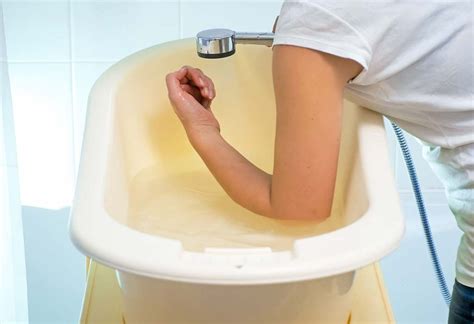 Gradually slip your baby into the tub feet first, using one hand to support her neck and head. check your baby's bath temperature by placing your elbow ...