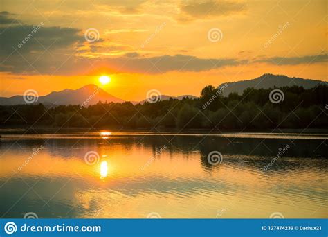 A Beautiful Colorful Sunset Landscape With Lake Mountain