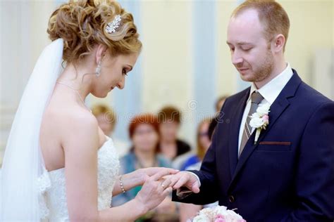 Beauty Bride And Handsome Groom Are Wearing Rings Each Other Stock