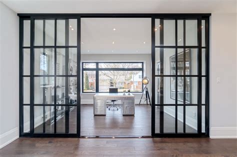 Glass Room Dividers Separating A Home Office From A Living Room With
