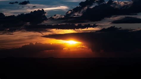 Download Wallpaper 1366x768 Sunset Clouds Sun Twilight
