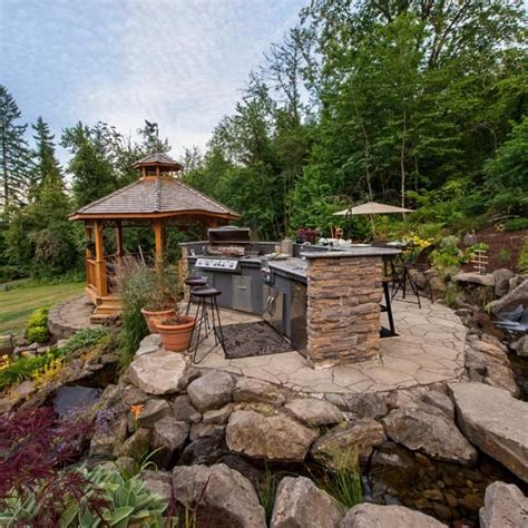Outdoor Living Space Is Complete With Fireplace Kitchen And Flat