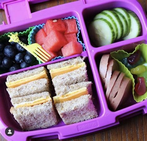a purple lunch box filled with lots of food