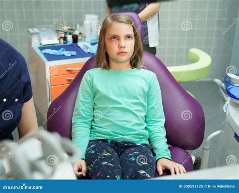 Little Scared Girl Sitting In Chair In Dentist Doctor Office Kidchild