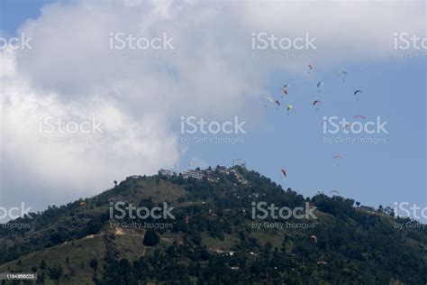 Paragliders Flying Against The Himalayas Pokhara Nepal Stock Photo
