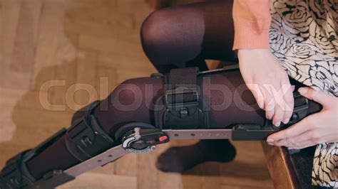 Lady Putting On Supportive Leg Brace Stock Image Colourbox