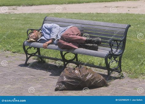 Homeless Man Sleeping On A Park Bench Los Angeles California