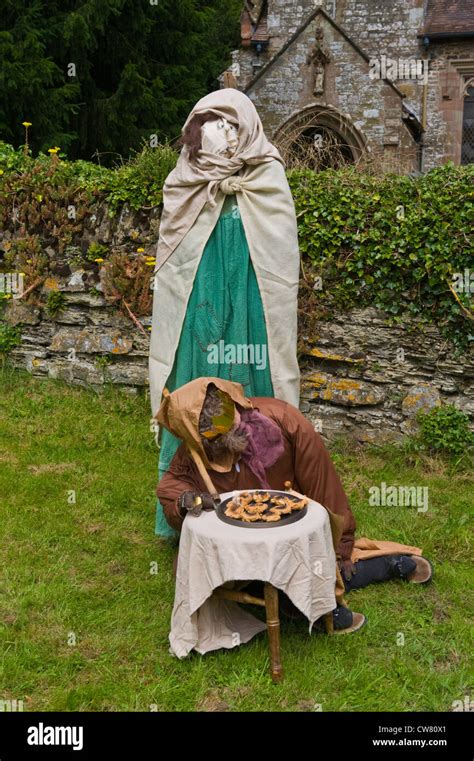 Effigies Of Medieval Characters Outside Church At Village Fete On