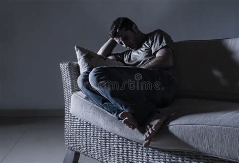 Young Sad And Desperate Man Awake Late Night On Bed In Darkness
