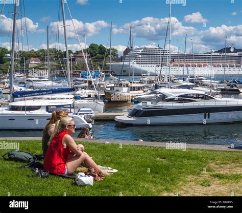 The Harbour In Oslo Norway With People Watching The Yachts And Boats