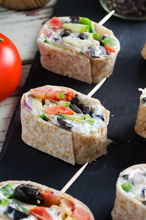 Easy finger foods to keep your guests satisfied—not to mention occupied—before the main event. Greek tortilla pinwheels (with video) - Scrummy Lane