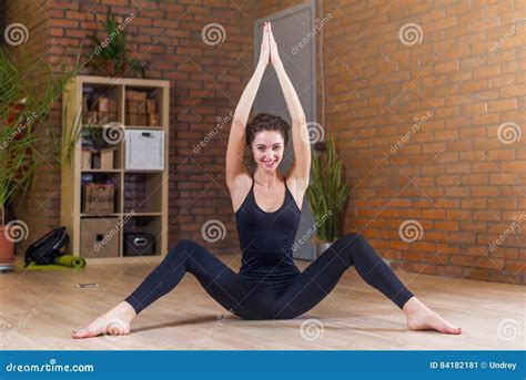 Portrait Of Beautiful Smiling Woman Doing Stretching Exercise Sitting