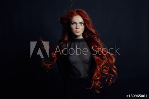 Portrait Of Redhead Sexy Woman With Long Hair On Black Background
