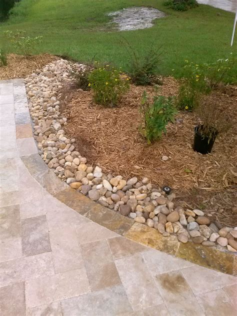 Using River Rock As A Drivewaylandscape Border To Stop Rainwater From