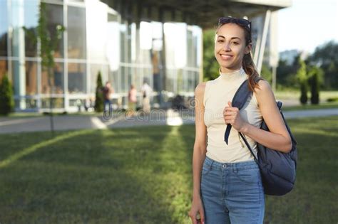 Portrait Of Smiling Female Student With A Backpack Going To College