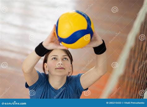 Young Girl Setting The Ball Over The Net Before Hitting It Stock Image