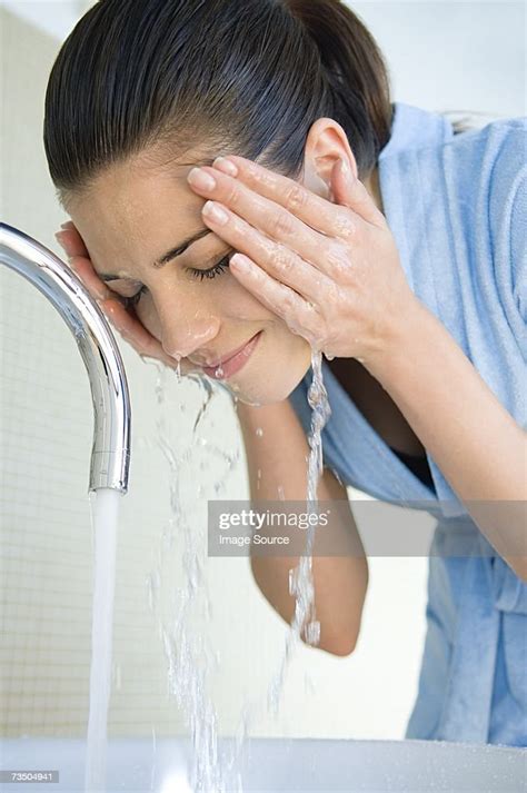 Woman Washing Face High Res Stock Photo Getty Images
