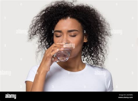 Thirsty Young African American Woman Drinking Clean Mineral Water Stock