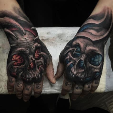 Evil Skulls One On Each Of Guys Hands One Has A Orange Glow And The