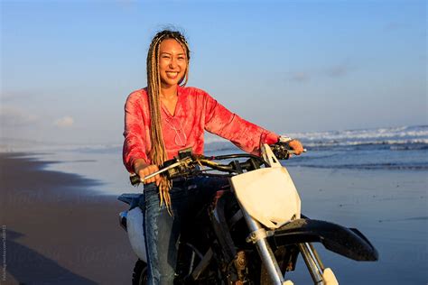 Young Woman Drenched After Bike Ride On The Beach By Stocksy
