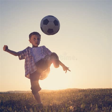 Young Little Boy Playing In The Field With Soccer Ball Stock Image