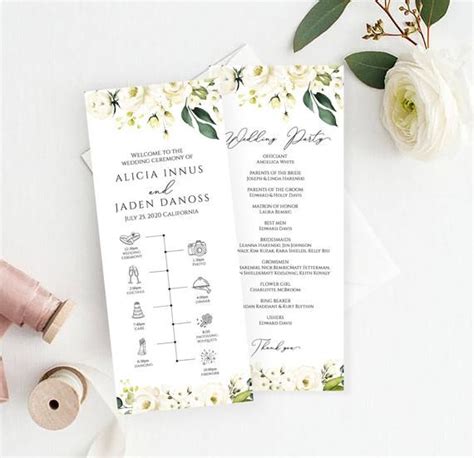 Two Wedding Programs With White Flowers And Greenery On Them Next To