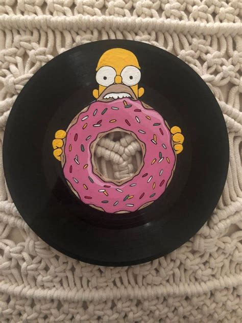 The record hangs daintily from a curly wire loop. Painted Simpsons Record 45 | Etsy in 2020 | Vinyl record ...