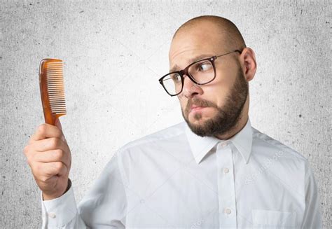 Bald Man Hand Holding Comb — Stock Photo © Billiondigital 118566464