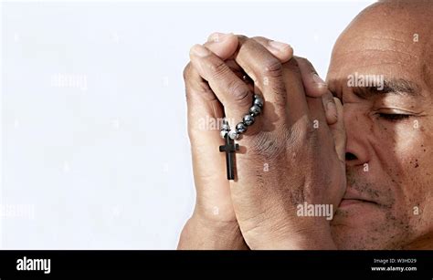 Black Man Praying To God With Cross And Hands Together Caribbean Man