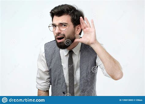 Curious Or Deaf Man Placing Hand On Ear Asking Someone To Speak Up Or