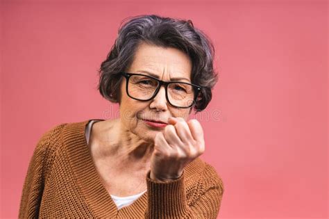 Portrait Of Angry Grey Haired Old Strict Senior Woman Wearing Glasses Pointing Up Threatening