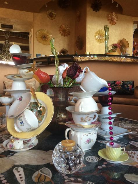 Custom Centerpieces Of Precariously Stacked Teapots Cups And Plates