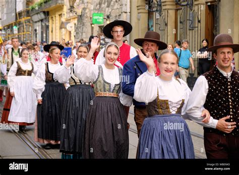 Slovenian Folklore Group In Local Costume Walking Down In Couples The