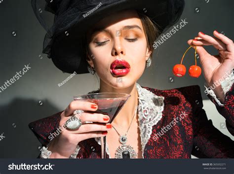 Vintage Woman Drinking Martini Glass Cherry Foto Stock